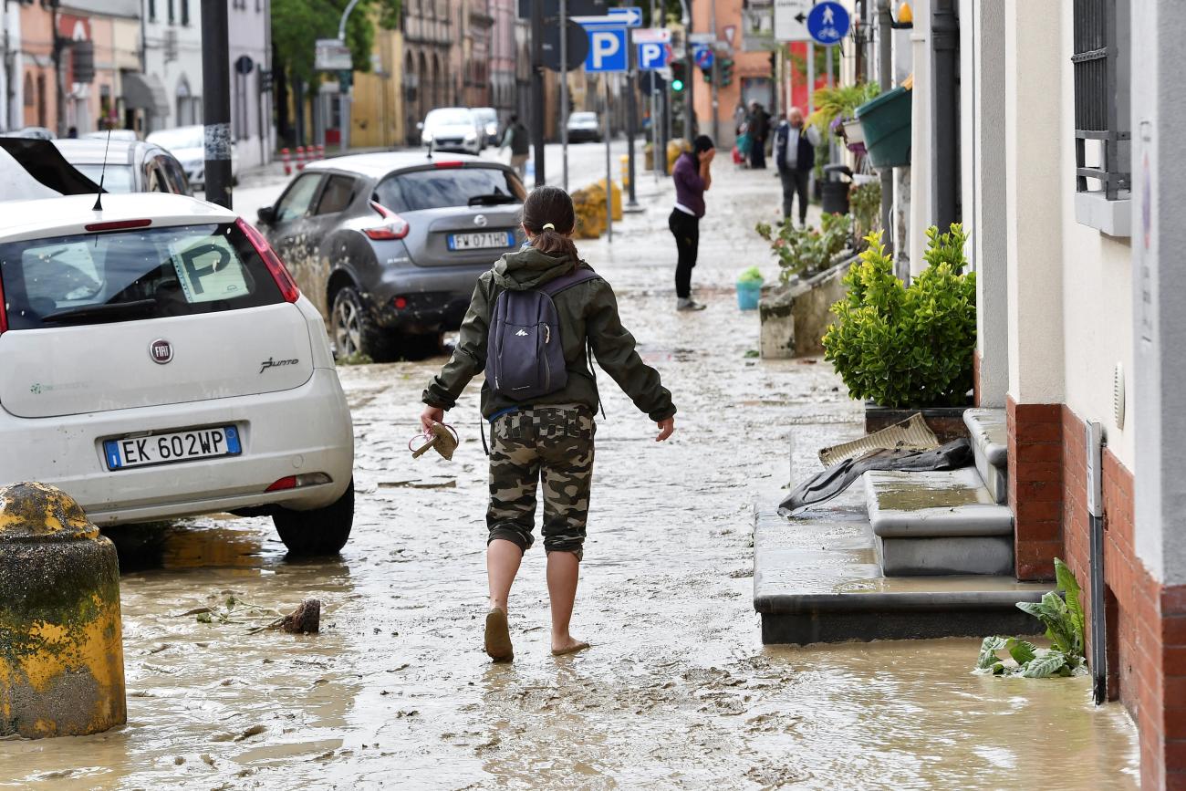 A person walks through mud after heavy rains hit Italy’s Emilia Romagna region, in Castel Bolognese, May 18, 2023. 