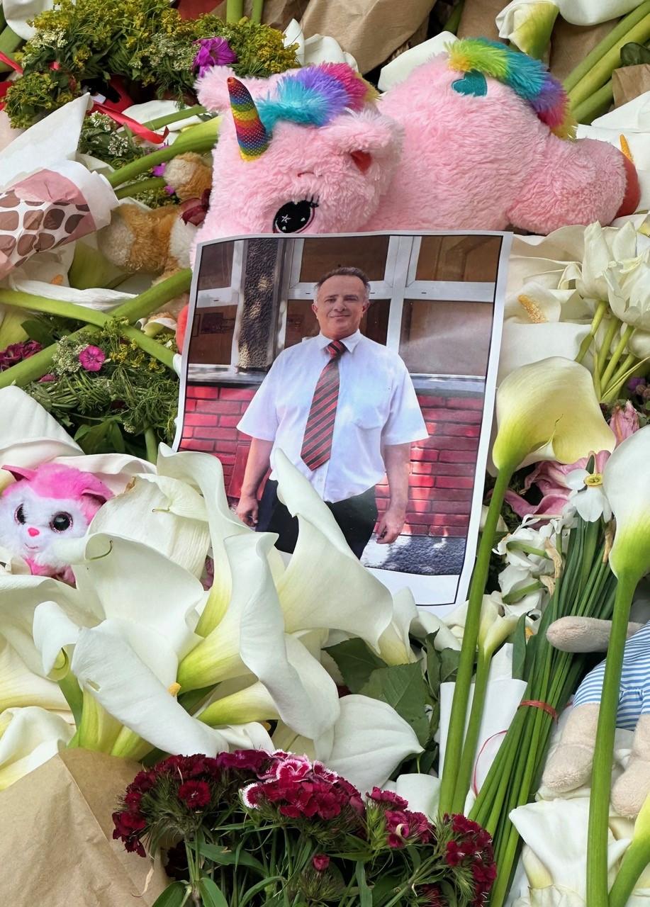 A photograph of beloved Uncle Dragan on the top of the makeshift memorial in front of Vladislav Ribnikar, the school where the shooting happened, in Belgrade, Serbia.