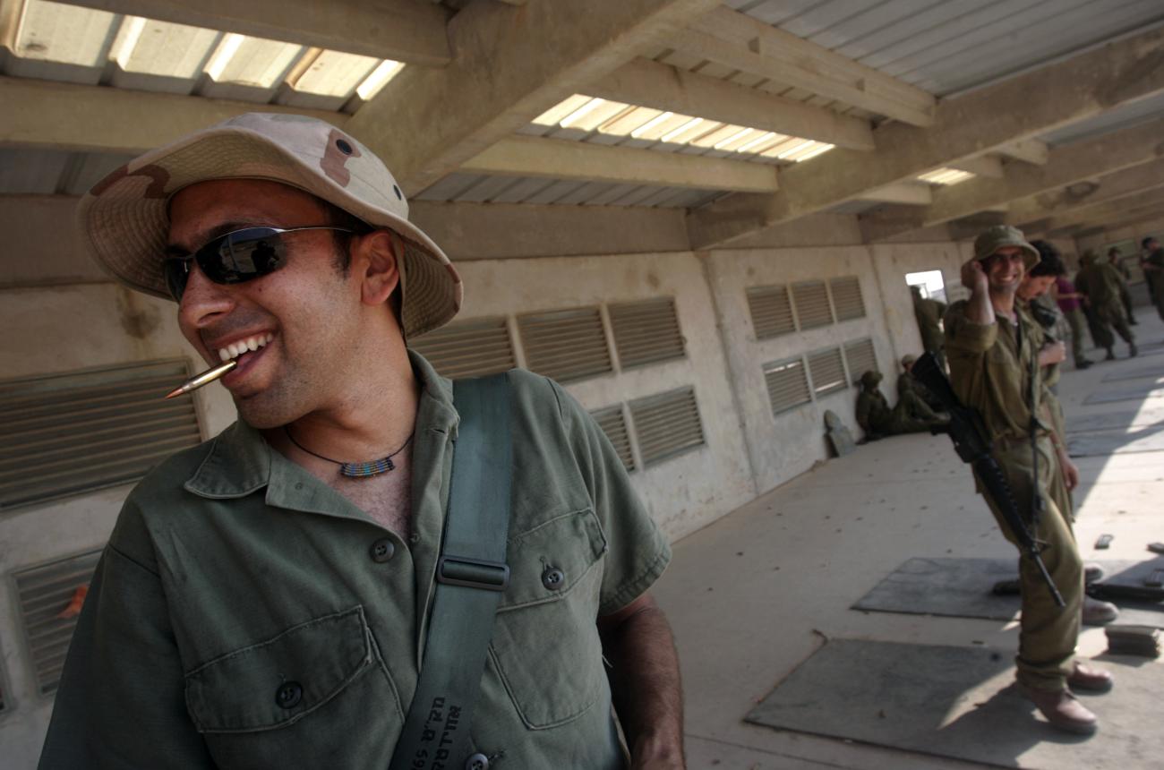 Israeli reserve soldiers smile during training after reporting for duty at the Elyakim military base near Haifa, Israel, on July 30, 2006.