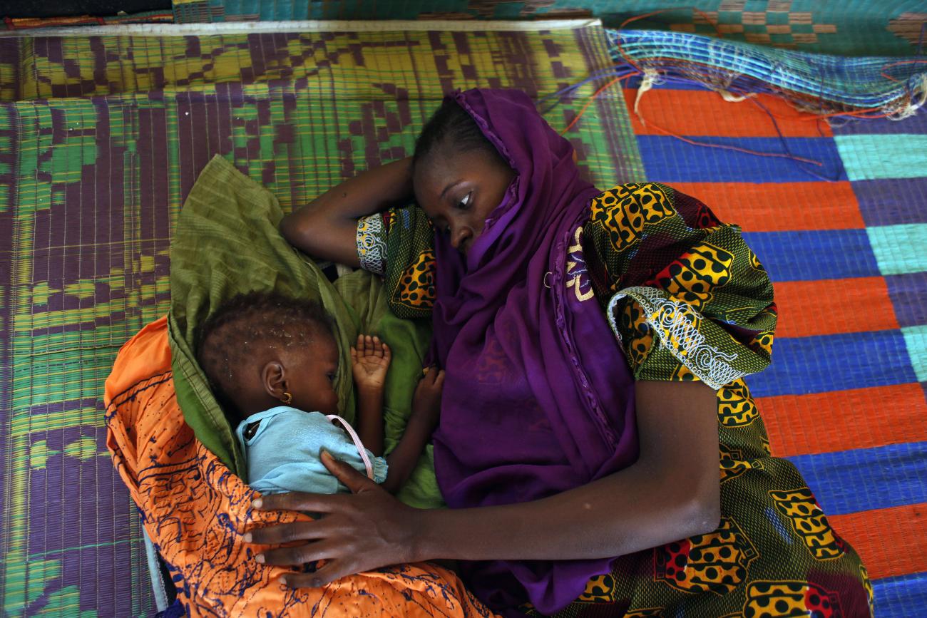 Bonko Diawara caresses her seventeen-month-old daughter Diarra Yattibere at a nutrition center at Selibaby's hospital, in the Guidimakha region, Mauritania, on June 3, 2012.