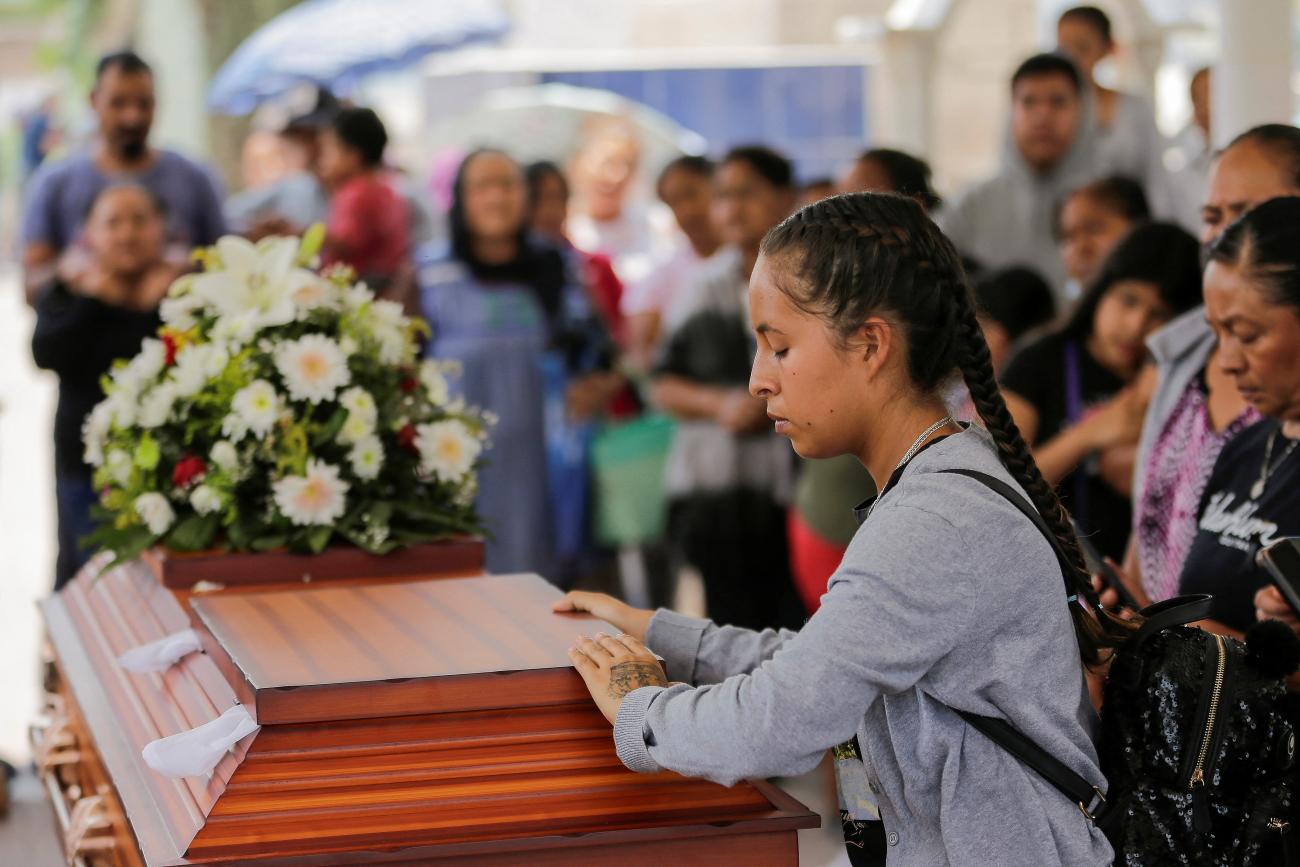 A relative reflects during the funeral of Teresa Magueyal, who was gunned down by assailants on a motorcycle on May 2, 2023, at a cemetery in Celaya, Mexico, May 5, 2023.