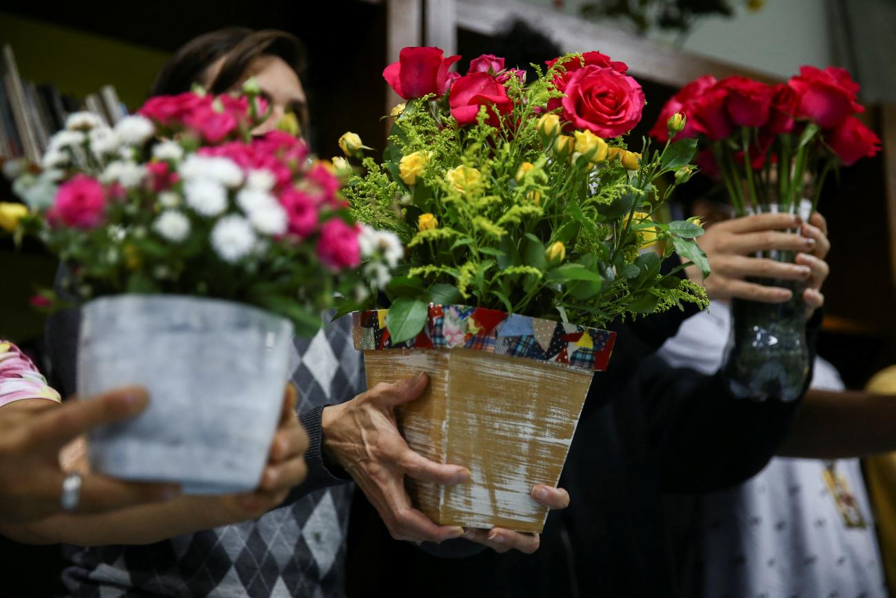 Hospital das Clinicas' Psychiatry Institute patients show their flower arrangements, made in a workshop as a form of occupational therapy, in Sao Paulo, Brazil