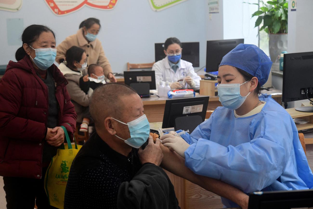 A medical worker administers a dose of the vaccine against COVID-19 to an elderly resident at a community health service center in Jinhua, Zhejiang province, China, on December 5, 2022.