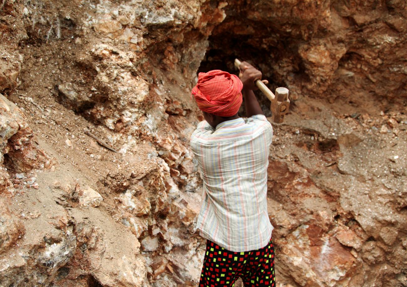 Babloo, 16, uses a hammer to break away pieces of mica in Giridih district in the eastern state of Jharkhand, India, June 27, 2016.