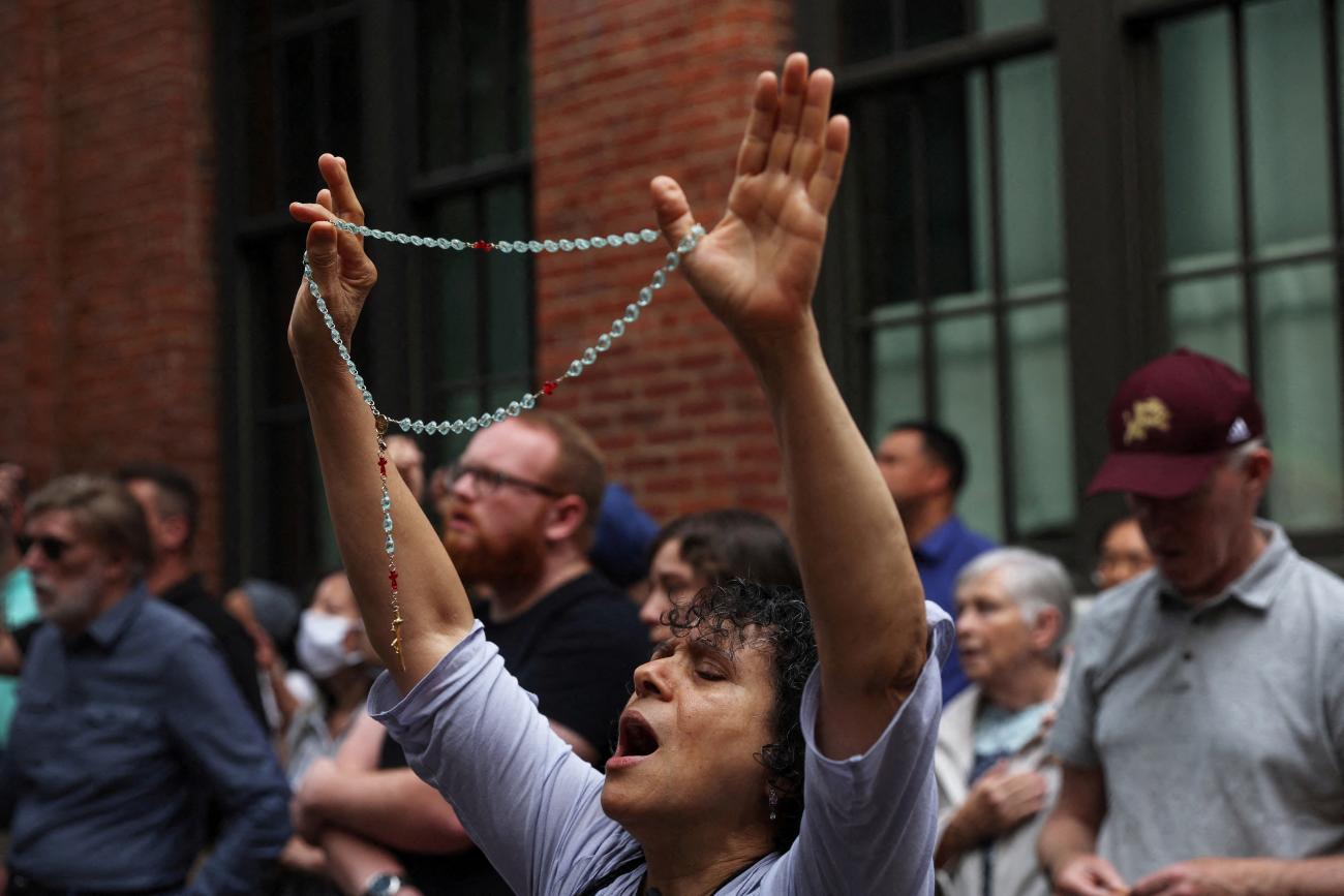 A person holds a rosary in a crowd of anti-abortion activists praying outside the Planned Parenthood Manhattan Health Center in New York City. 