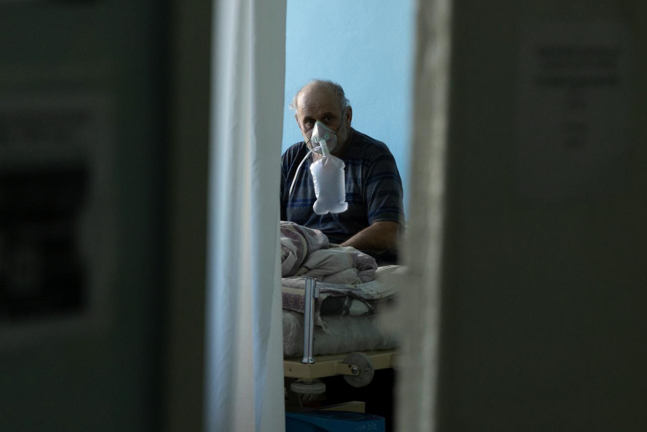 A patient suffering from COVID-19 receives oxygen support at the intensive care unit (ICU) of the City Clinical Hospital Number 3 in Kyiv, Ukraine, October 26, 2021.