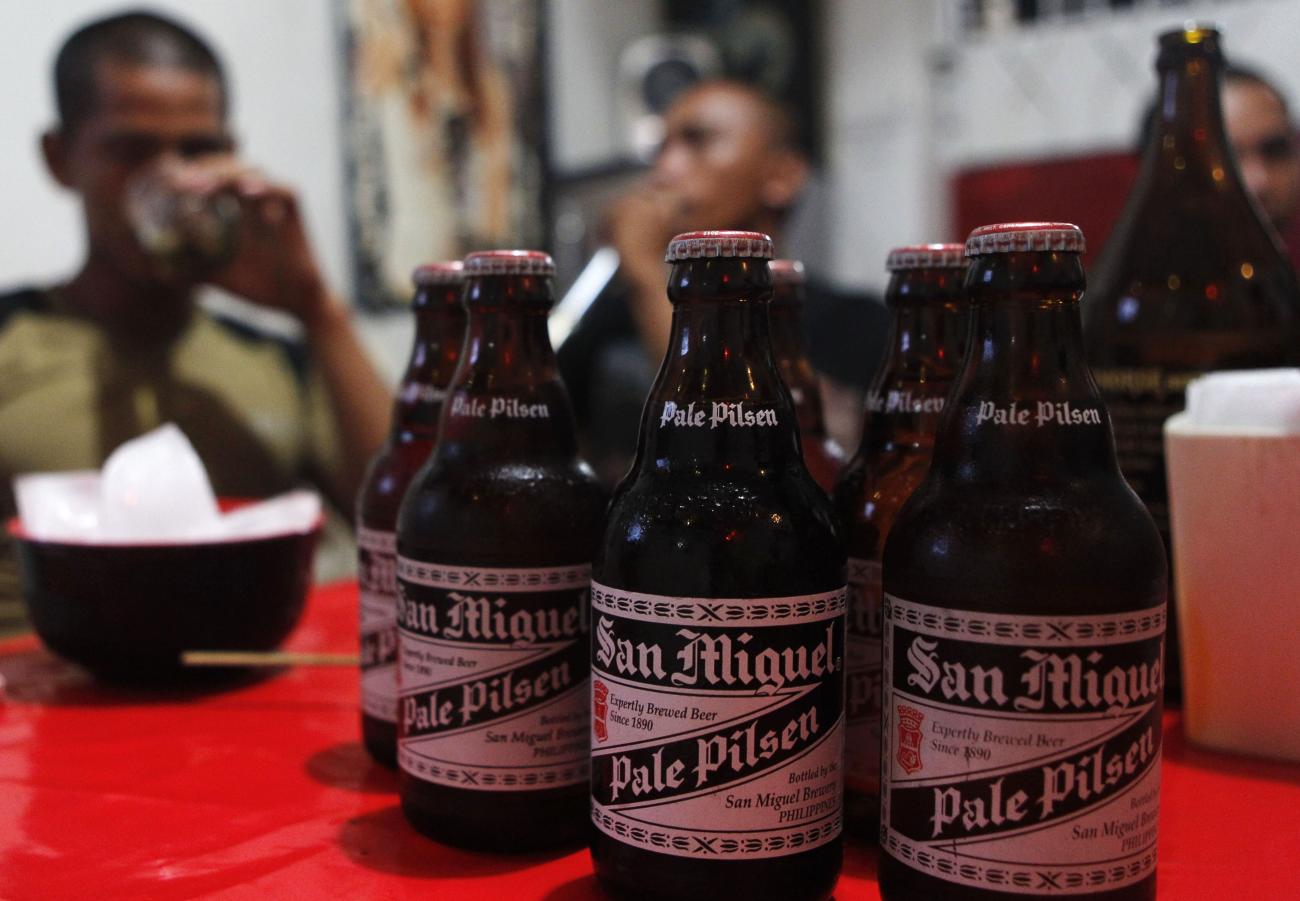 Men drink San Miguel beer at a bar in Taguig City, Metro Manila, November 14, 2012.