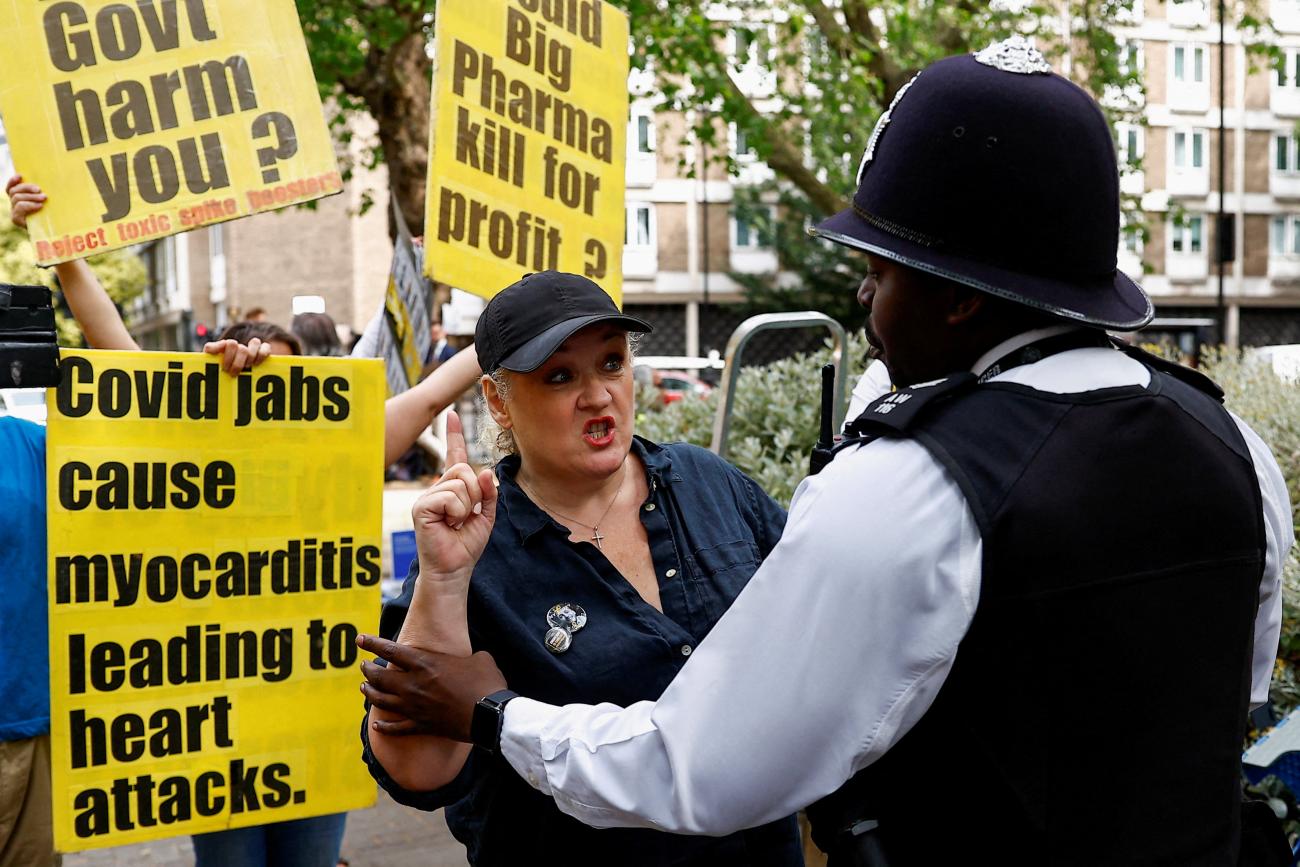 A police officer detains an anti-vaccine demonstrator outside the COVID-19 Inquiry, in London, Britain, June 27, 2023,
