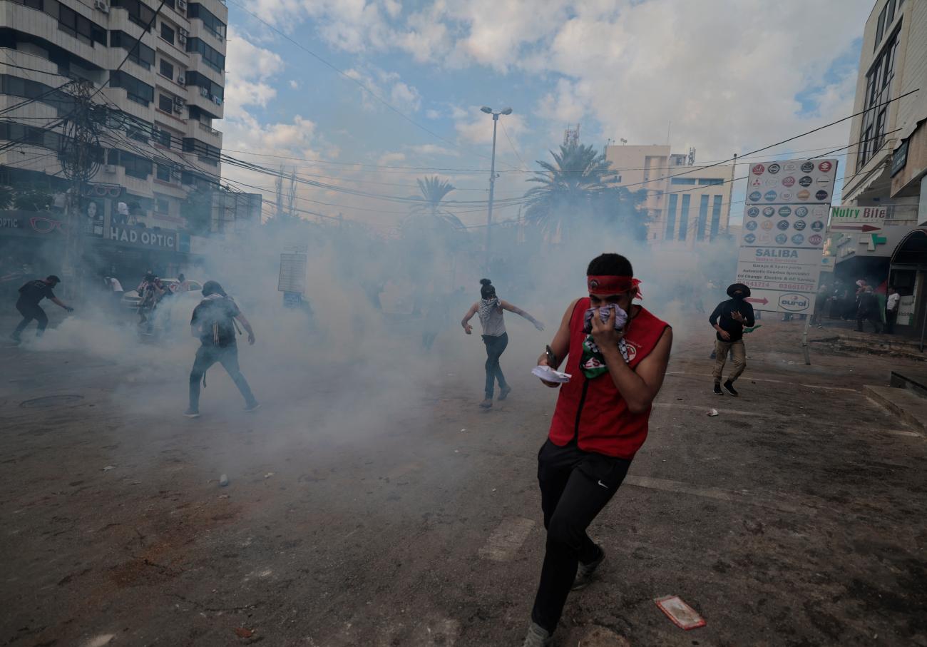 People clash with security forces during a protest near the U.S. embassy in Awkar, after hundreds of Palestinians were killed in a blast at Al-Ahli hospital in Gaza that Israeli and Palestinian officials blamed on each other, Lebanon October 18, 2023. 