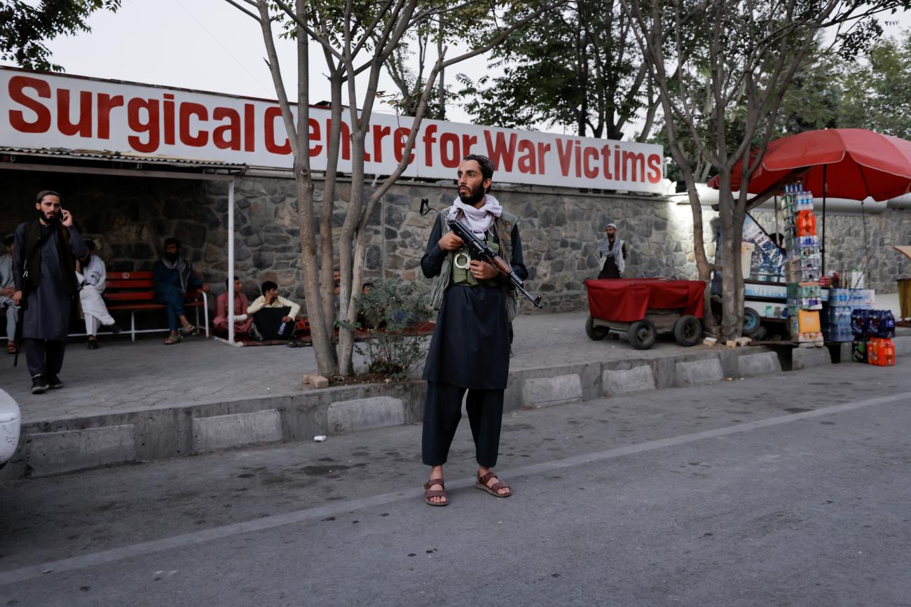 An armed member of Taliban forces stands outside an emergency hospital, after several civilians were killed in an explosion, in Kabul, Afghanistan, on October 3, 2021.