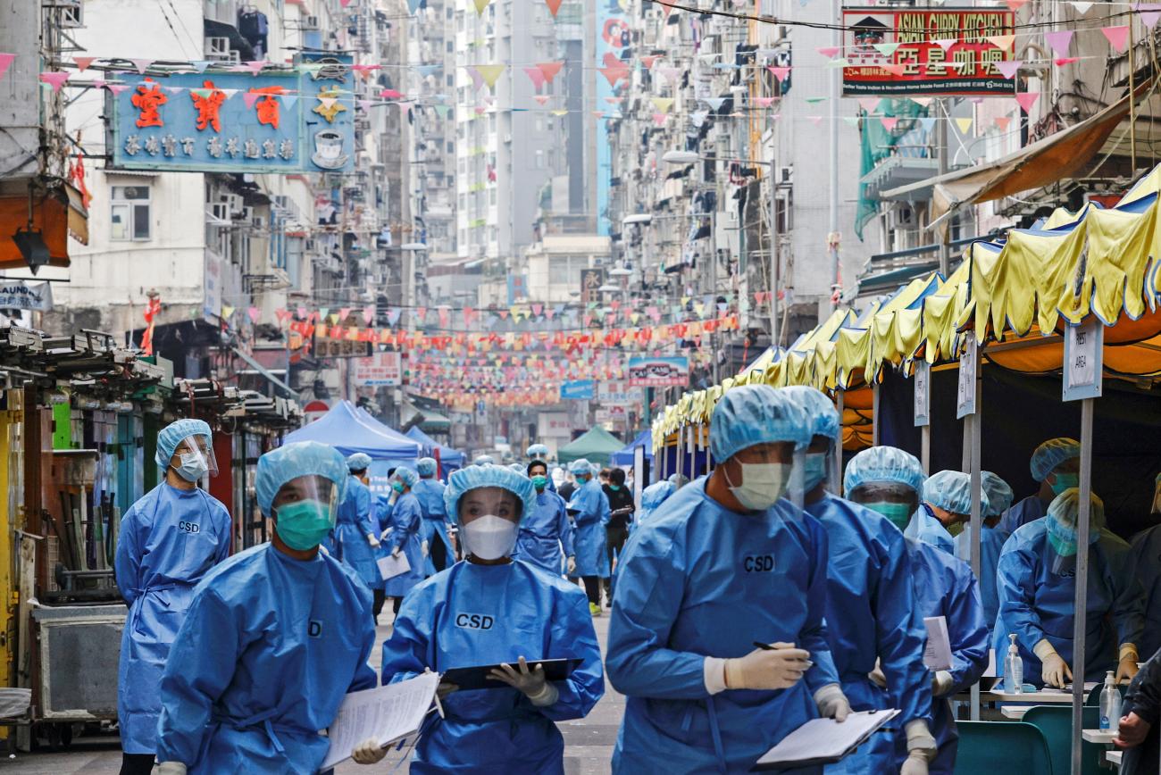 Health workers are seen in protective gear inside a locked down portion of the Jordan residential area