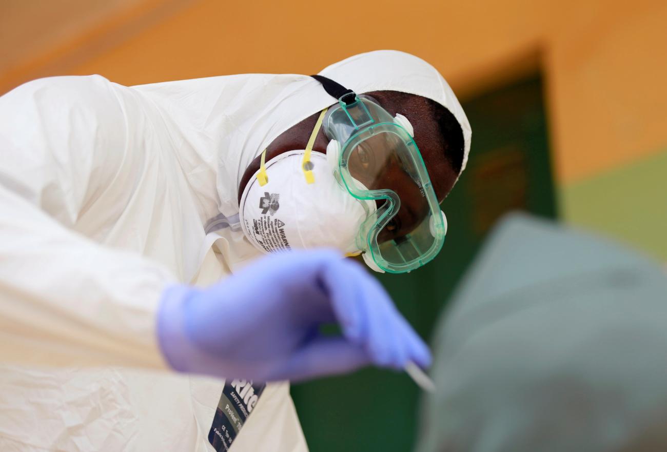 A medical worker takes a sample for COVID-19.