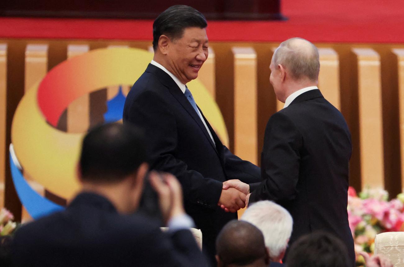 Chinese President Xi Jinping greets Russian President Vladimir Putin as they attend the opening ceremony of the Belt and Road Forum