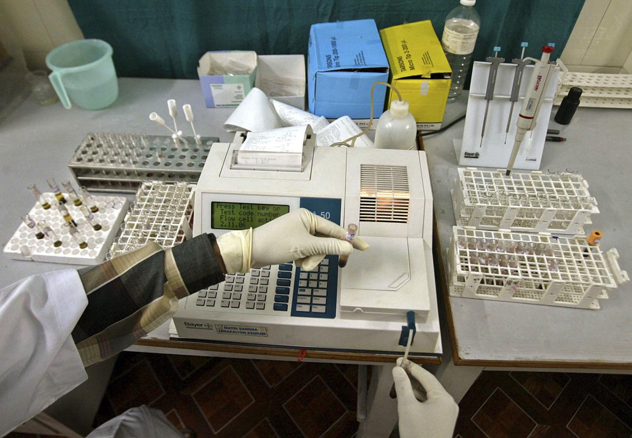 A laboratory assistant examines blood samples.