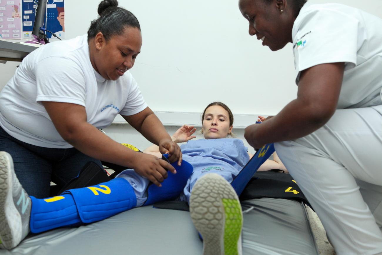 Nursing assistants being trained in the use of a non-pneumatic anti-shock garment (NASG).