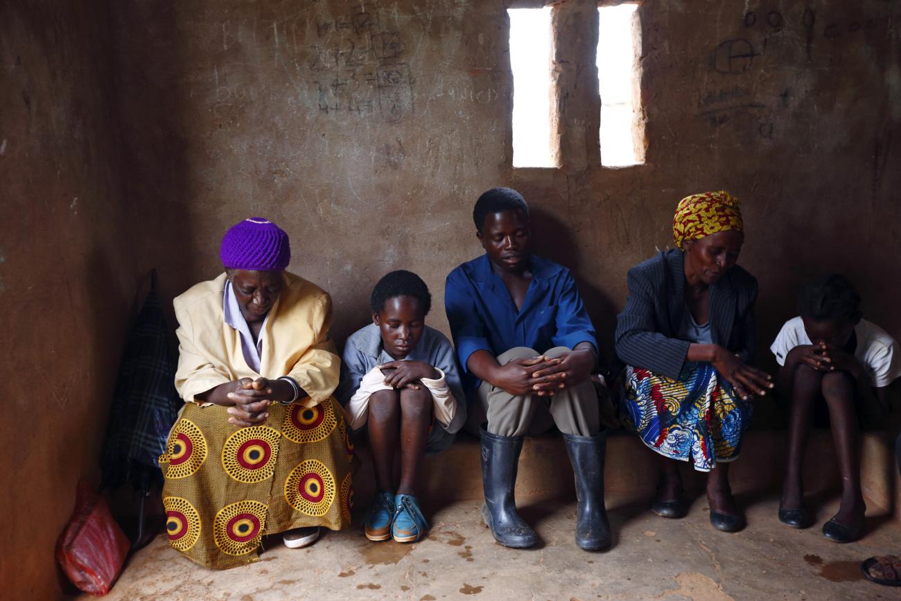HIV-positive members of a self-help group pray at the start of a meeting.