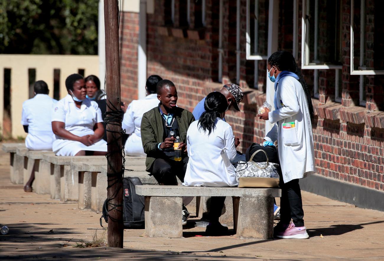 Zimbabwean medical workers sit outside Sally Mugabe Hospital.