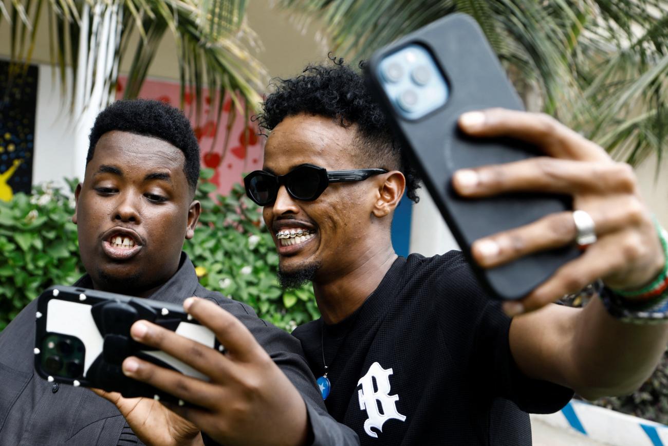 Somali youth use their mobile phones to record videos on social media app TikTok.