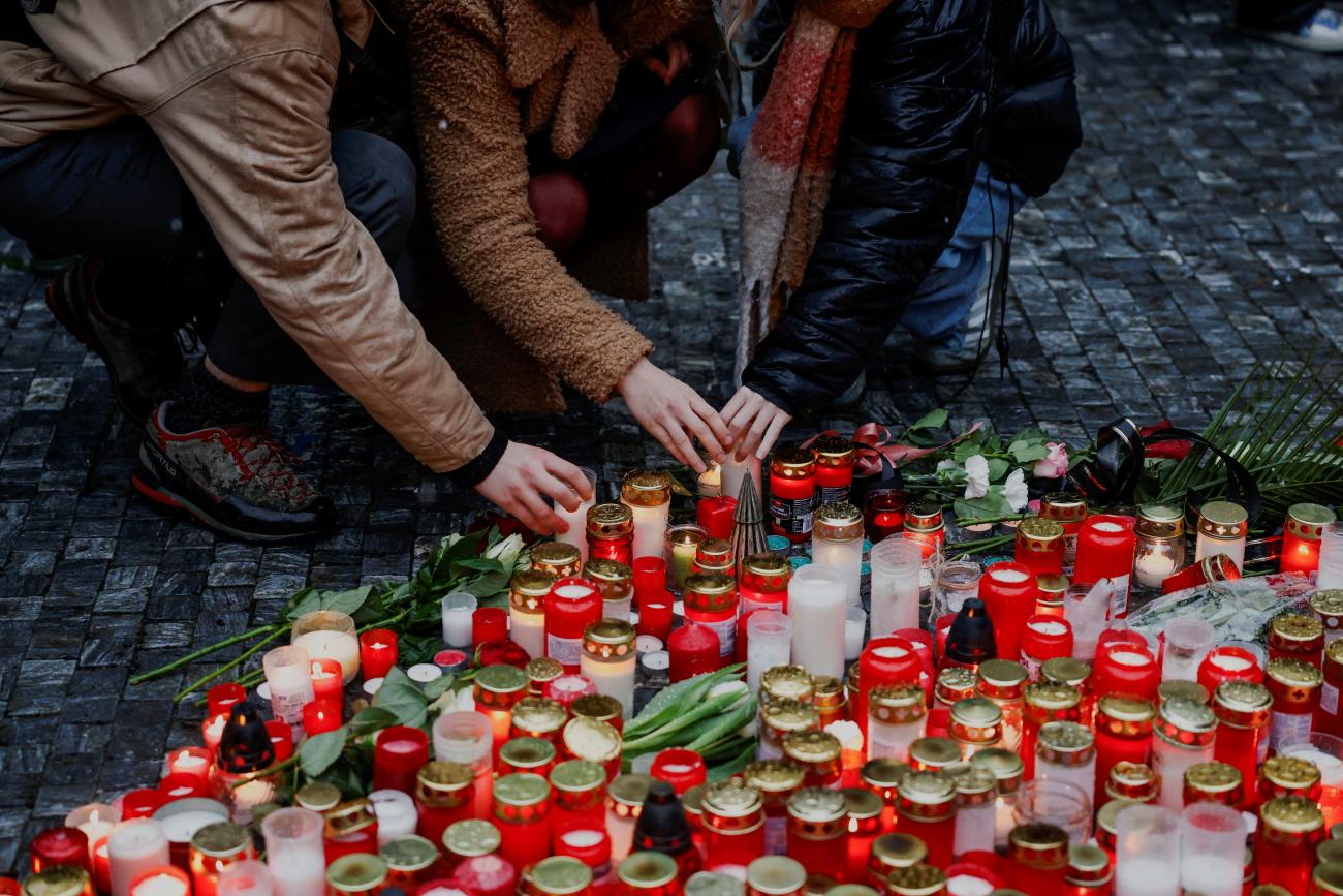 People light candles at a memorial during a vigil following a shooting at one of Charles University's buildings.