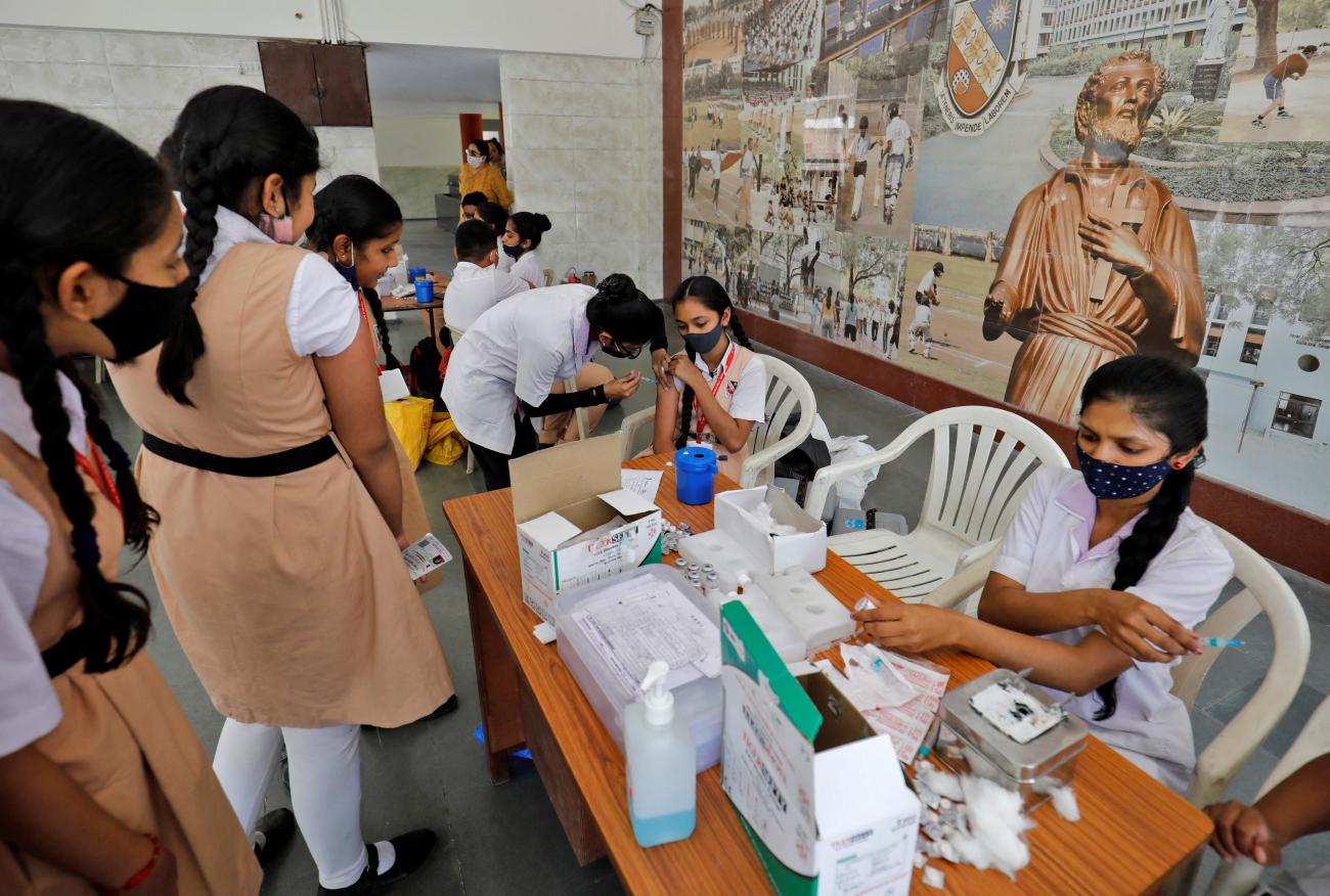 A girl receives a dose of Biological E's COVID-19 vaccine.