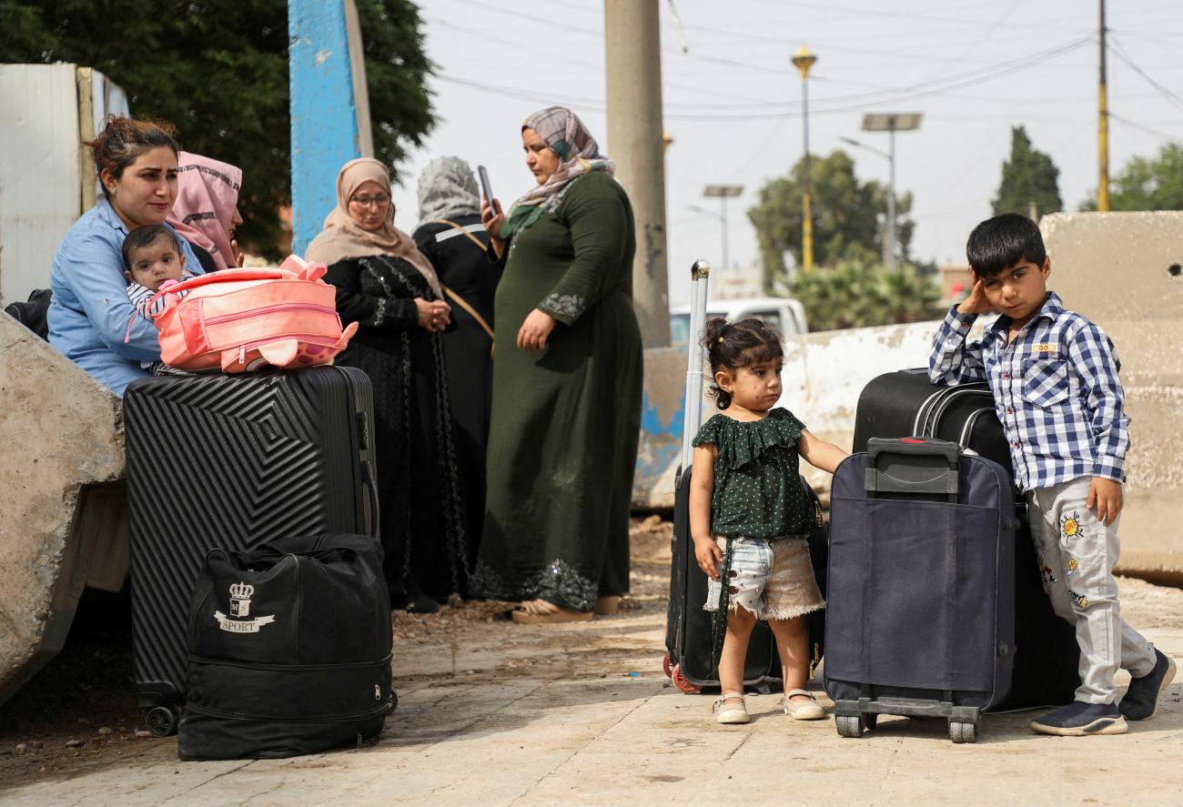 Syrian Kurds, who were evacuated from Sudan, arrive in the Kurdish-controlled city of Qamishli.