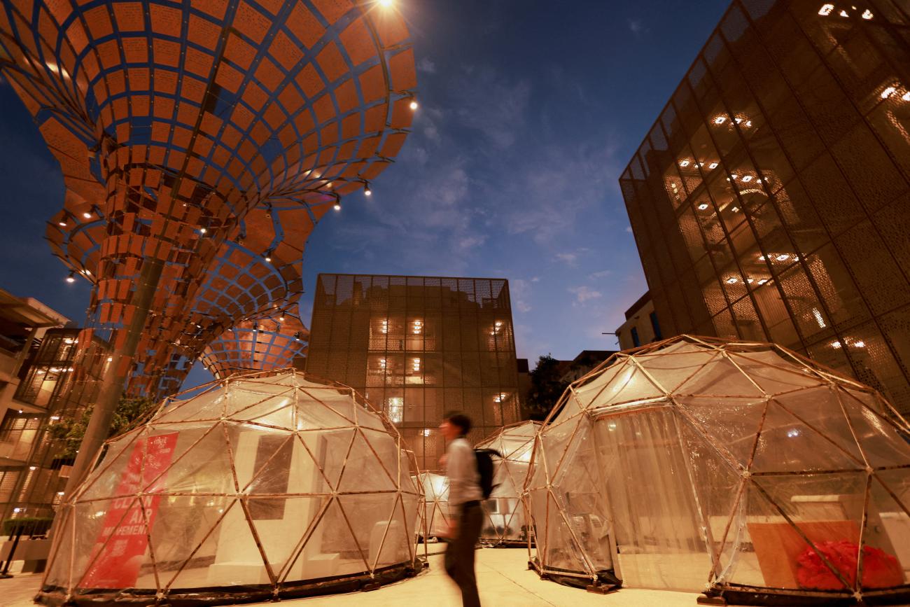 A man walks past a pollution pod designed to mimic the air quality in New Delhi.