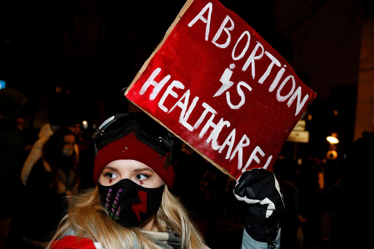 A demonstrator holds a placard during a protest against the verdict restricting abortion rights.