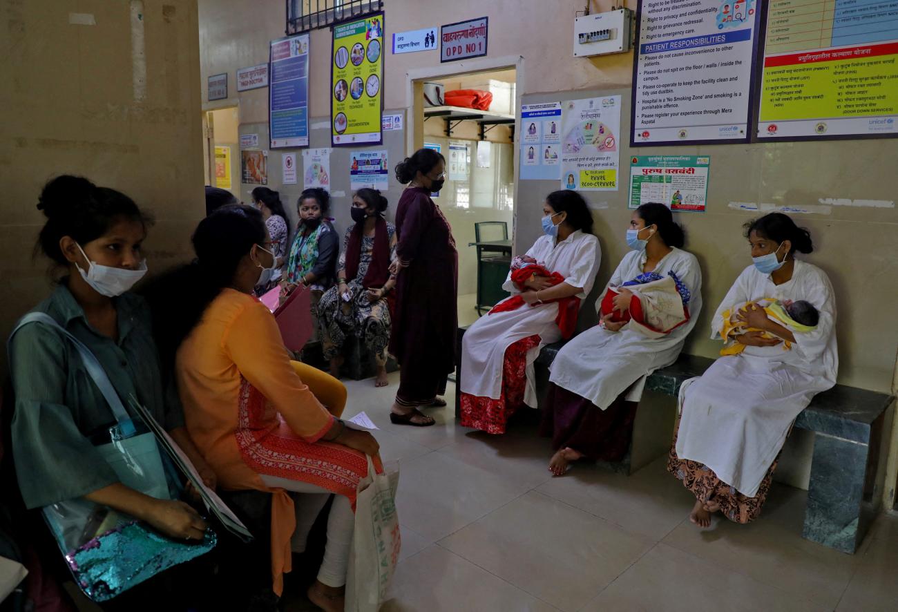 Mothers with their newborn babies wait for a check-up as other women wait for their turn to get antenatal examination outside a doctor's room at a maternity hospital in Mumbai, India, April 25, 2023.