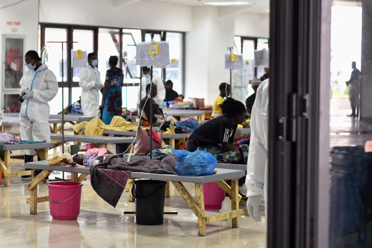 People receive treatment at an emergency cholera facility that was set up to deal with a deadly outbreak at the National Heroes Stadium.