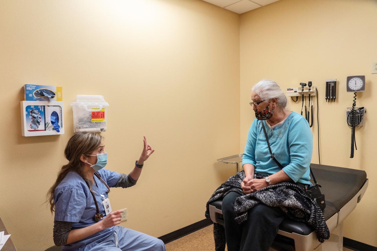 Dr. Eileen Sprys talks to her patient Luisa Alvarado.