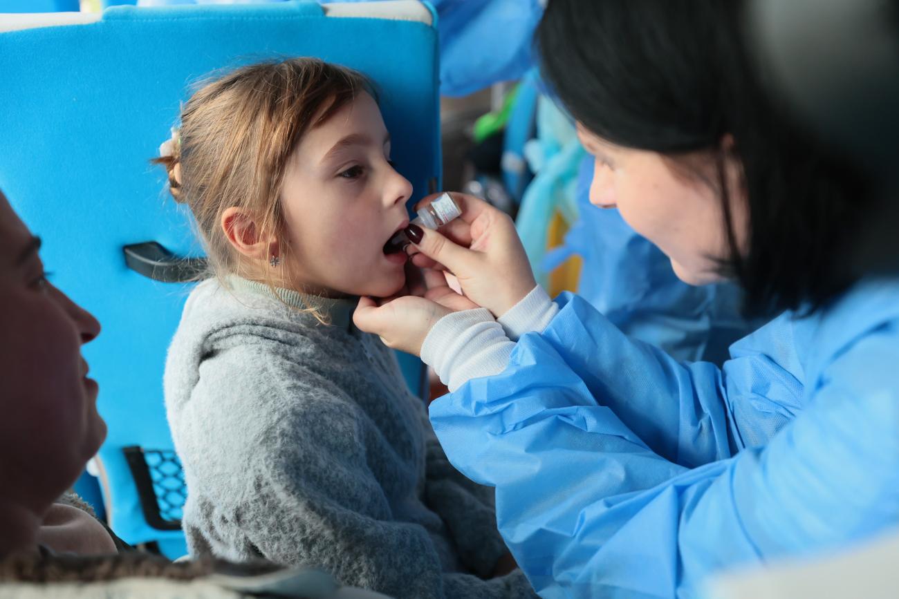 A girl receives a vaccination during field a vaccination session.