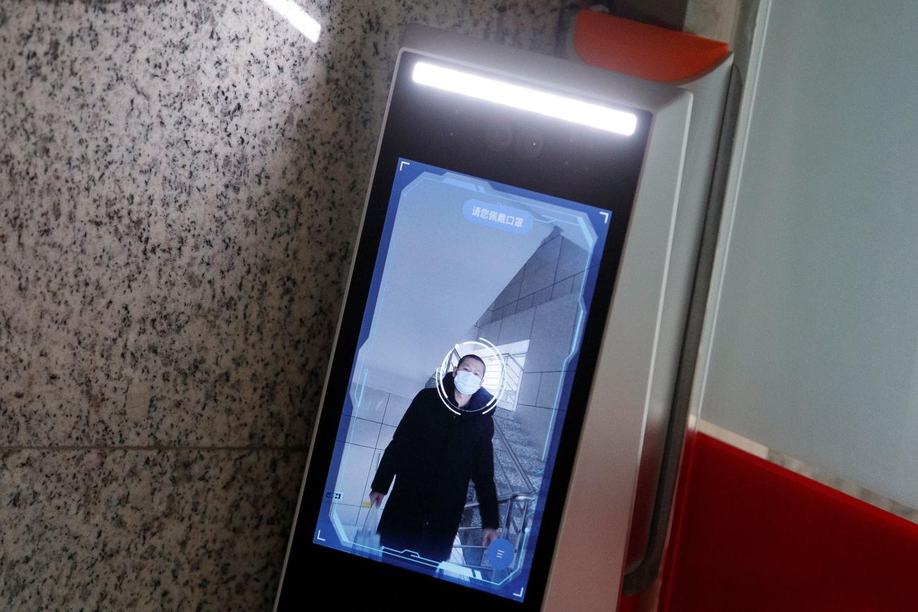 A man has his face scanned by a facial recognition device that identifies people when they wear masks to gain access to Hanwang (Hanvon) Technology, in Beijing, China, on March 6, 2020.