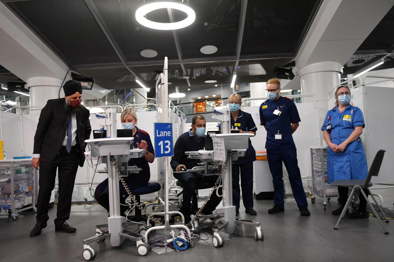 Staff prepare to administer injections of a COVID-19 vaccine at a NHS mass vaccination center at the Millennium Point Center.
