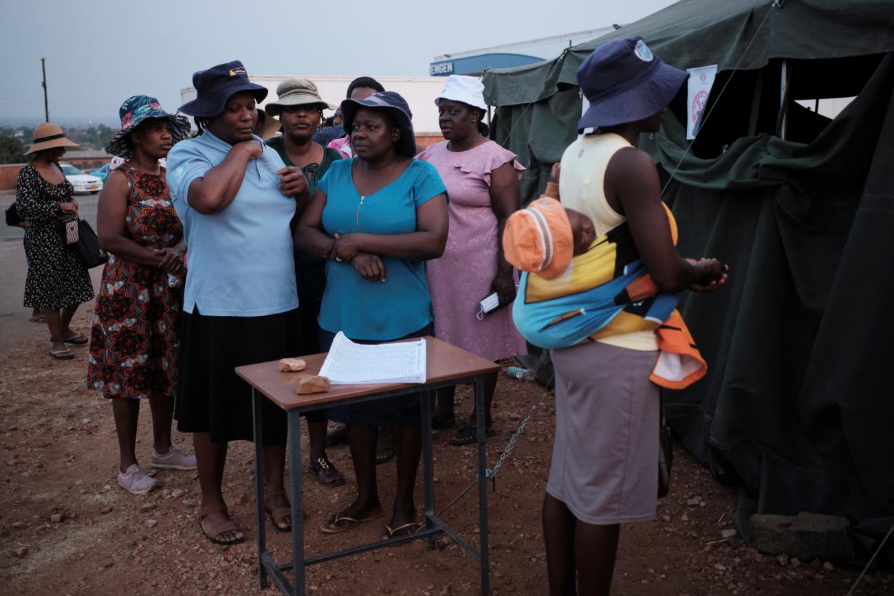 Women wait for their turn to cast their votes at a polling station.