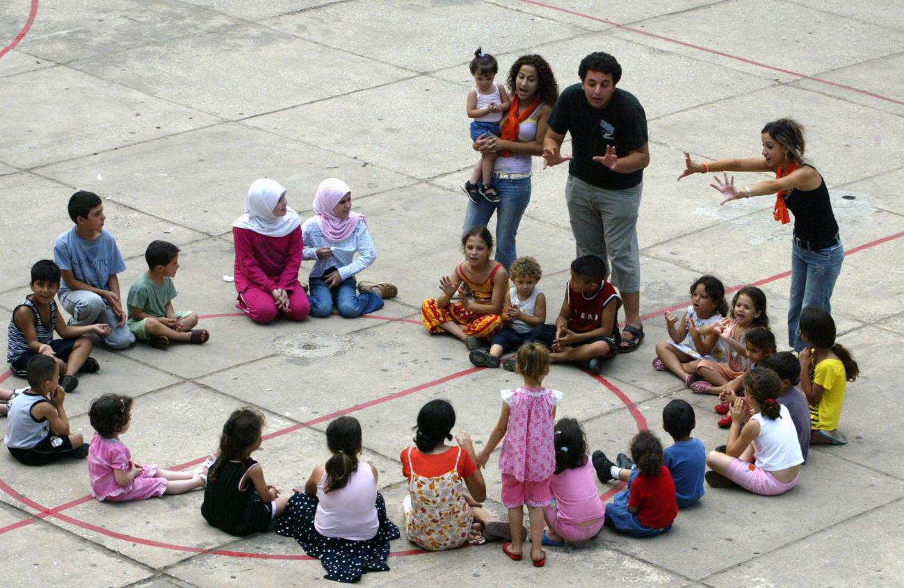 Lebanese children play in a school after their families fled from Israeli attacks.