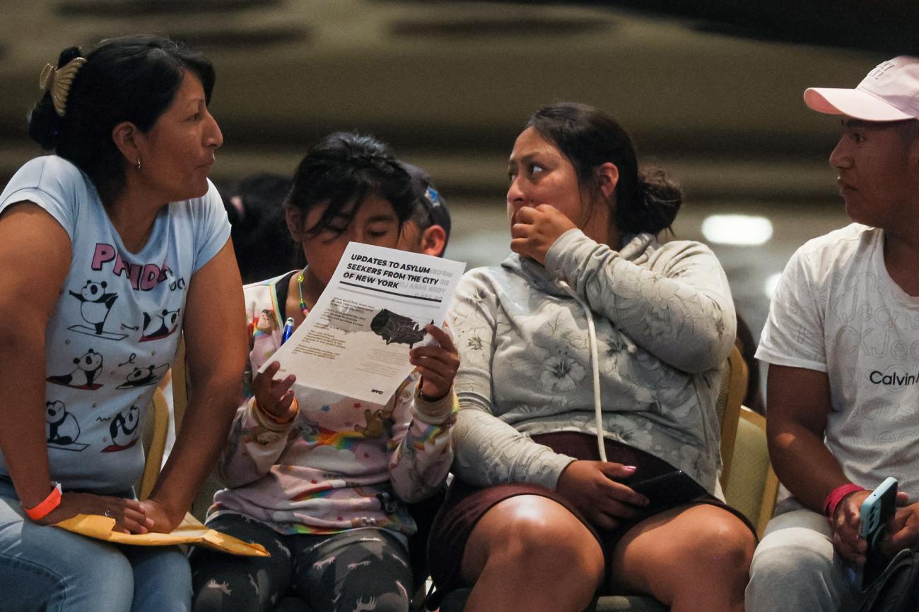 Asylum-seekers are seen inside the Roosevelt Hotel where migrants are currently being processed and housed in New York City.