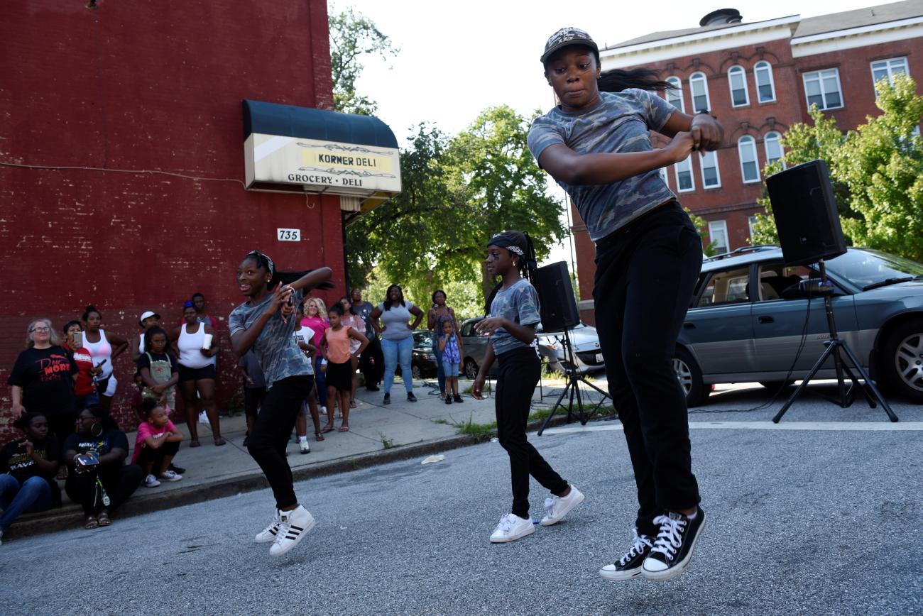 Girls dance at the "Huddle Up on the Wood" event and Cease Fire Community Jubilee during the 72 hour community-led Baltimore Ceasefire against gun violence in Maryland, August 4, 2017.