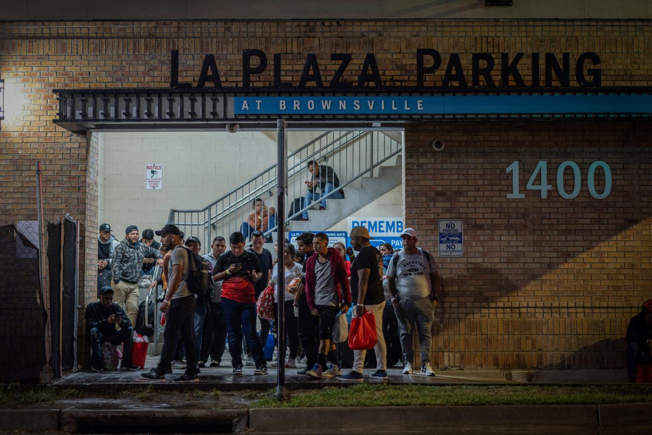 Migrants stand at a processing center as they wait for a bus to Chicago, in downtown Brownsville, Texas, U.S., October 24, 2023. The Republican-led state of Texas said it has spent at least $100 million since April 2022 to bus tens of thousands of migrants who recently crossed the U.S.-Mexico border to Chicago, New York, Denver, and other Democratic-led cities.
