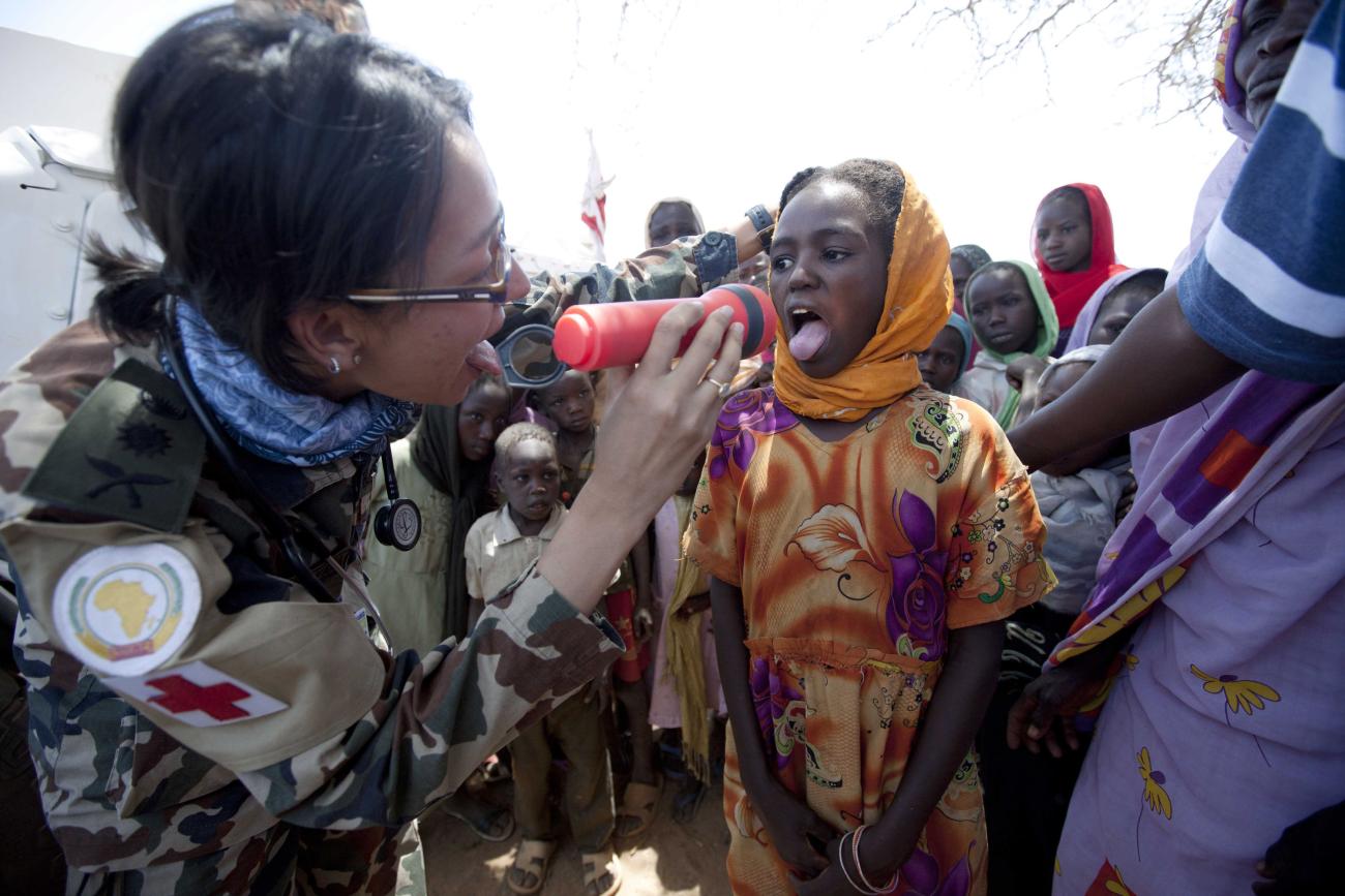 A child receives a medical checkup from members of the Nepalese Special Forces from UNAMID.