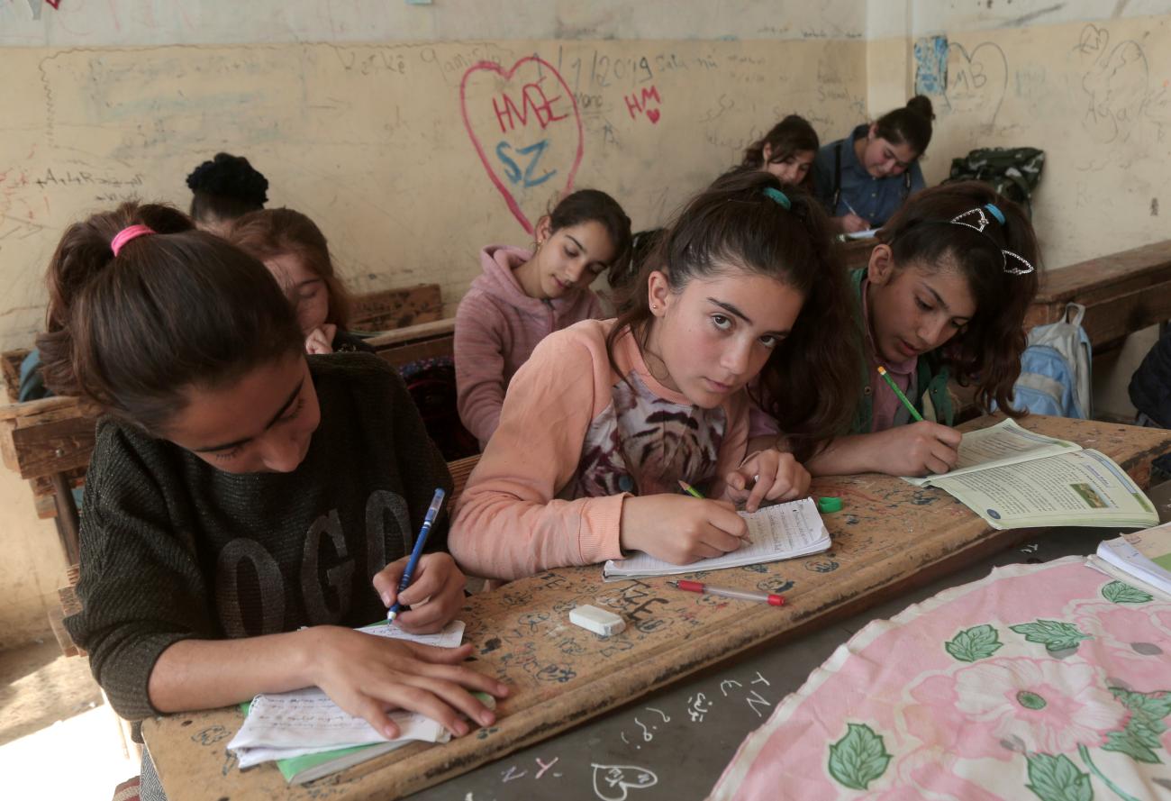 Kurdish students attend class at a school.