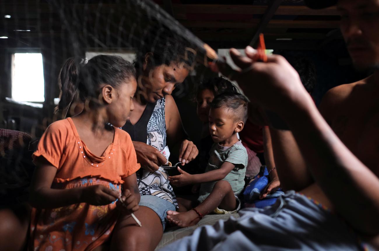 Adelaida Marquez serves ready-to-use therapeutic food to her 15-month-old son who has been diagnosed with malnutrition.