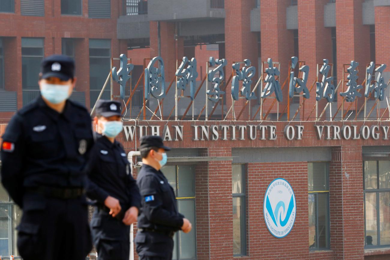 Security personnel keep watch outside Wuhan Institute of Virology during the visit by the WHO team tasked with investigating the origins of COVID-19, in Wuhan, China, on February 3, 2021.