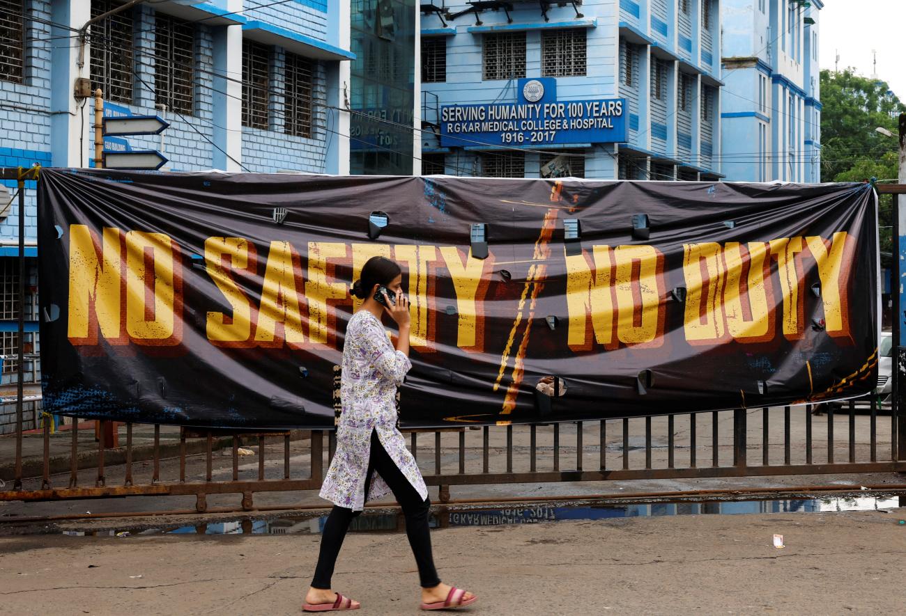 A woman walks past a closed gate of R G Kar Medical College and Hospital in Kolkata, India, August 19, 2024.