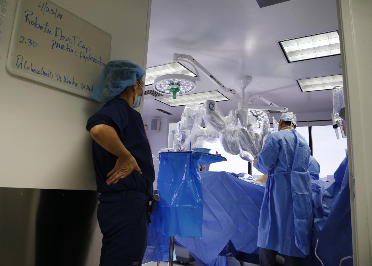 Doctors perform a single-site robotic-assisted hysterectomy on a 49-year-old woman, at miVIP Surgery Center, in Los Angeles, California, on April 23, 2014.