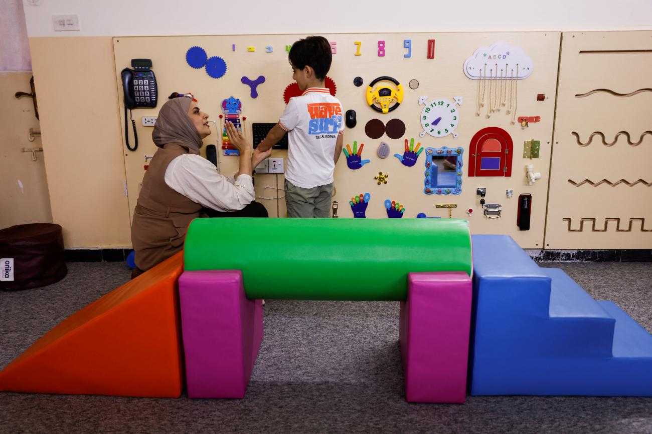 Shaimaa Ghassan Abdul Razak, who operates the Momayazoon Foundation, teaches an autistic student at the Foundation, in Baghdad, Iraq, on September 16, 2024.