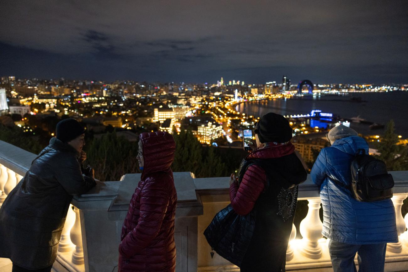 People look out at Baku's skyline as the city hosts the United Nations Climate Change Conference (COP29), in Azerbaijan, on November 14, 2024.