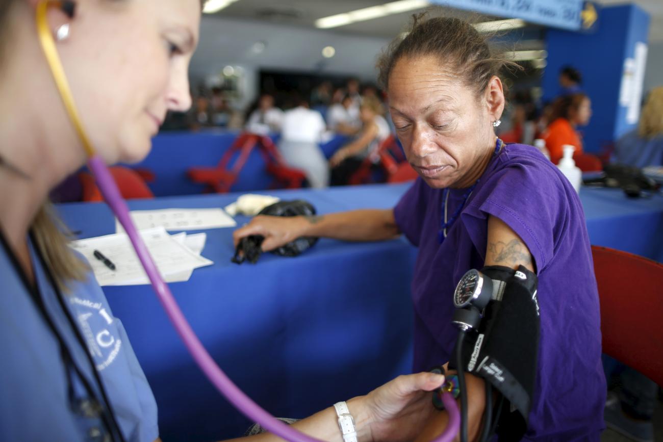 A woman has her blood pressure taken at the Care Harbor free clinic, which offers free medical, dental, and vision care to the uninsured population, in Los Angeles, California, on October 15, 2015. 