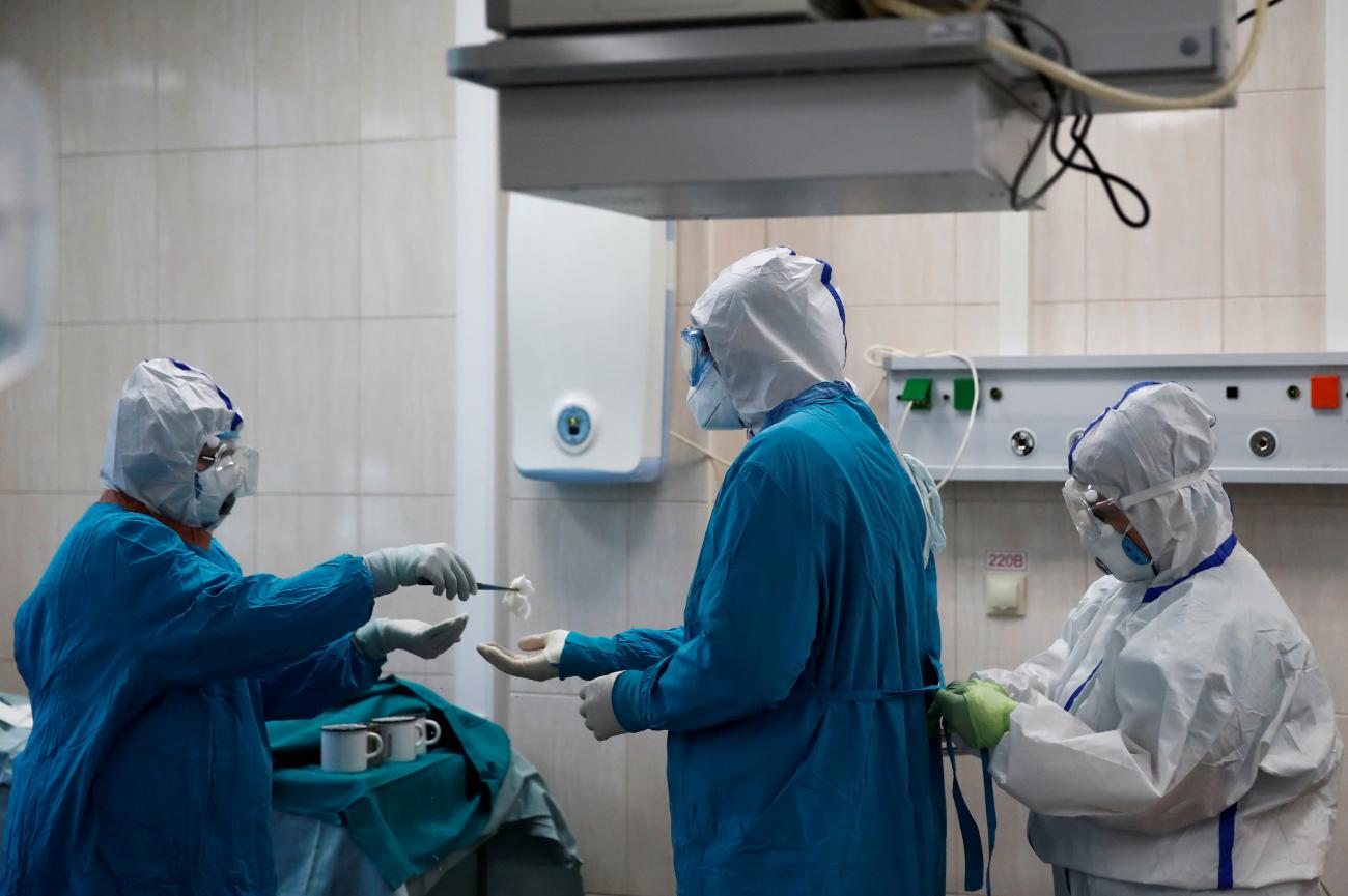 Islam Muradov, MD, prepares to perform an emergency surgery on a patient with COVID-19, in the operating room of the City Clinical Hospital Number 15, in Moscow, Russia, on May 25, 2020.