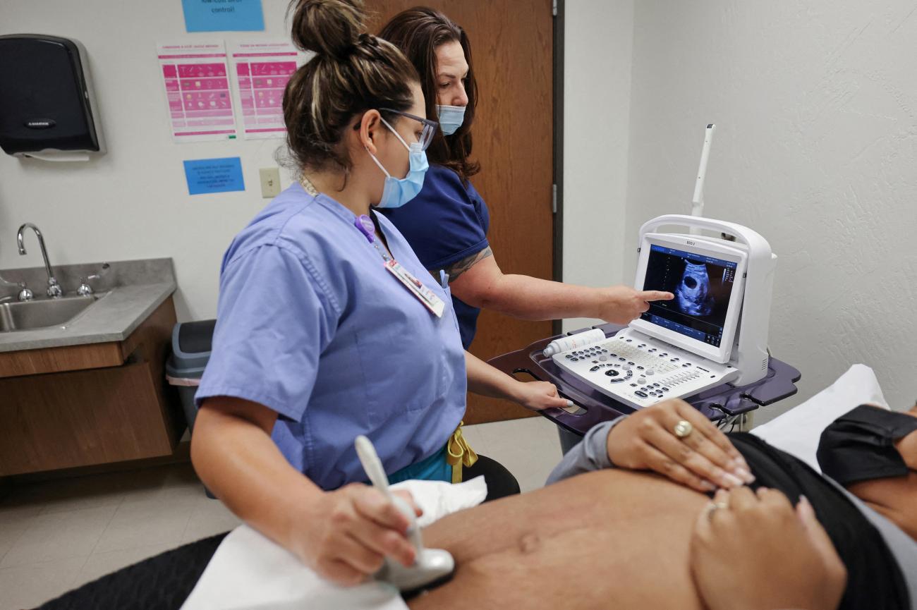 An ultrasound sonographer guides a resident during an ultrasound on a patient, before her surgical abortion at the Trust Women clinic in Oklahoma City, Oklahoma, on December 6, 2021.