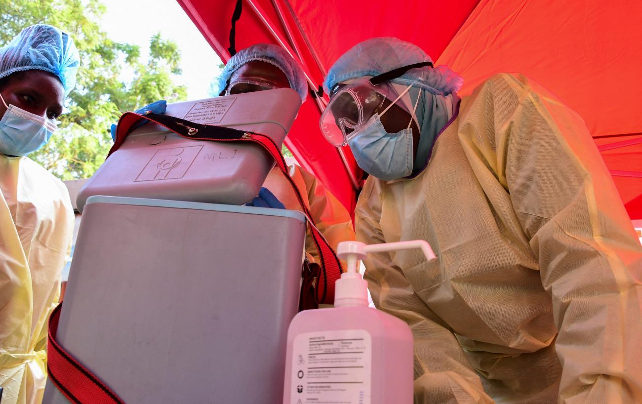 Doctors prepare to vaccinate a close contact of a patient who had tested positive during the launch of the vaccination for the Sudan strain of Ebola virus, in Kampala, Uganda, on February 3, 2025.